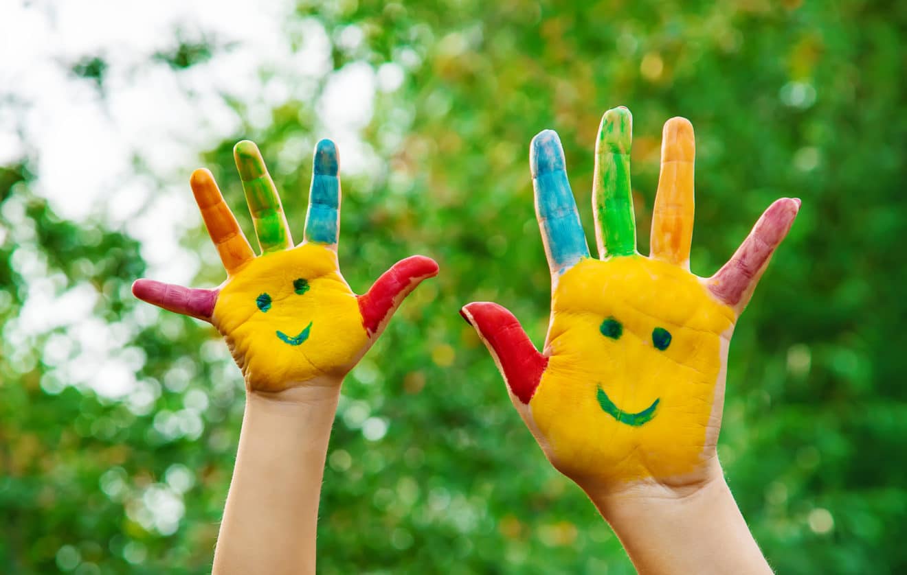 children hands in colors. Summer photo. Selective focus.